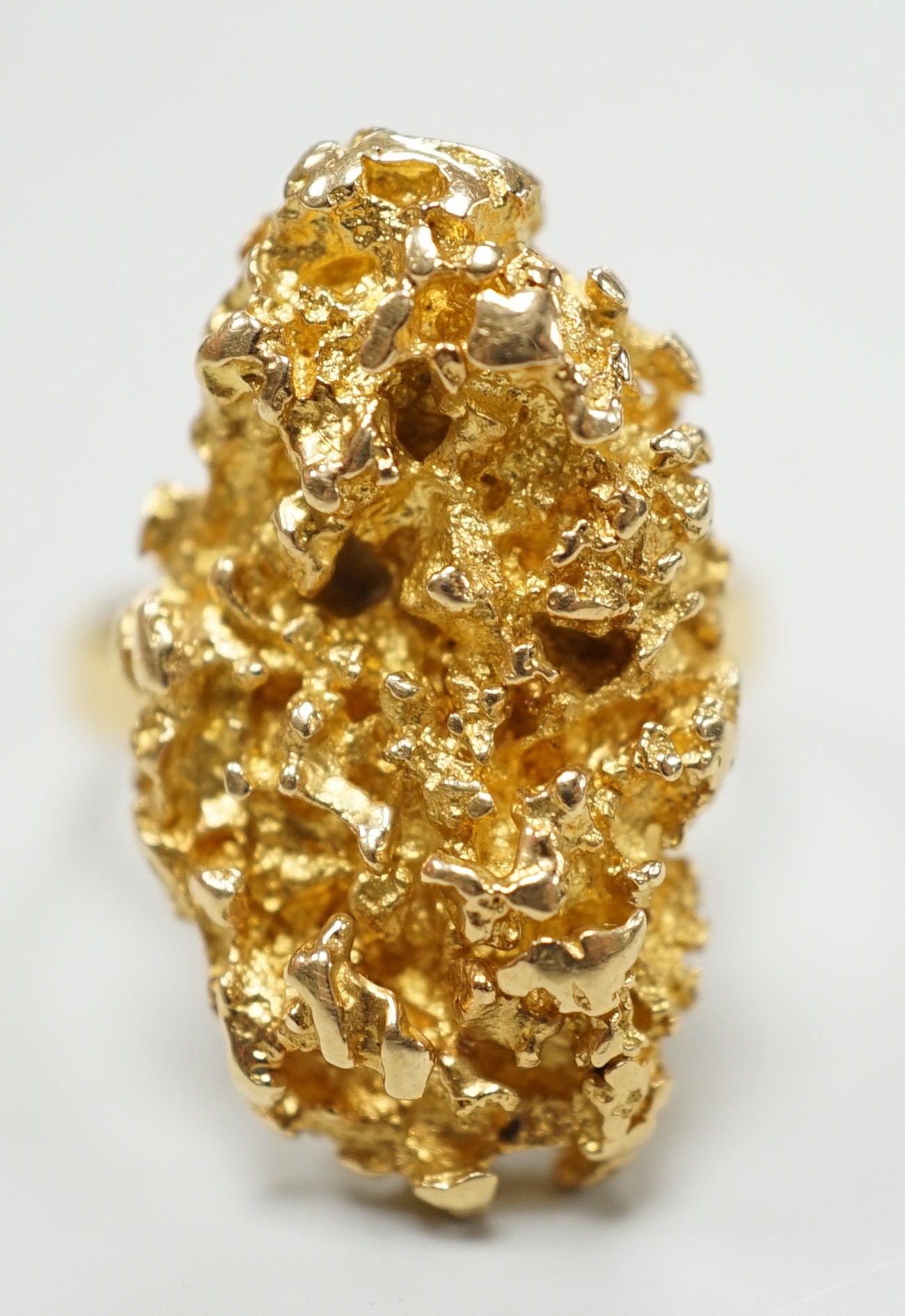 An African yellow metal nugget ring, size M/N, 15.3 grams.